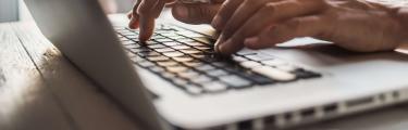 Close up of man using laptop
