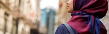 woman wearing red hijab in a city