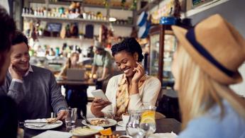 People sitting in a cafe eating lunch laughing